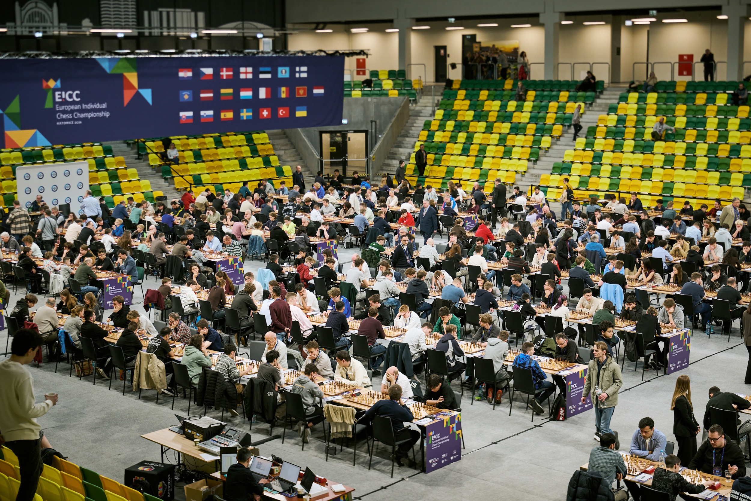 Dziesiątki par graczy grających w szachy