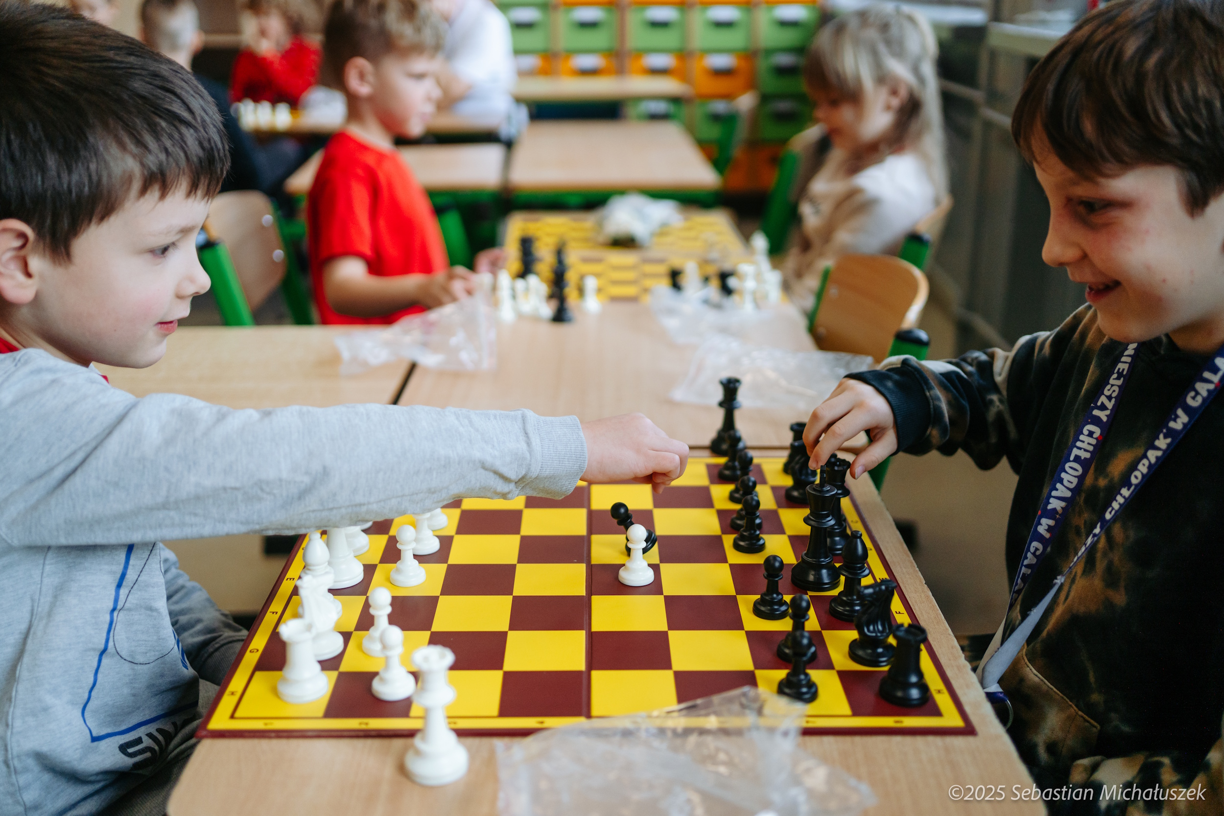 Dzieci grające w szachy z robotem